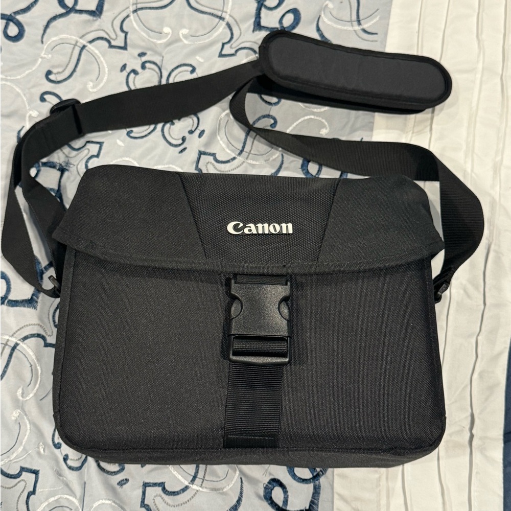 Black Canon two compartment camera bag